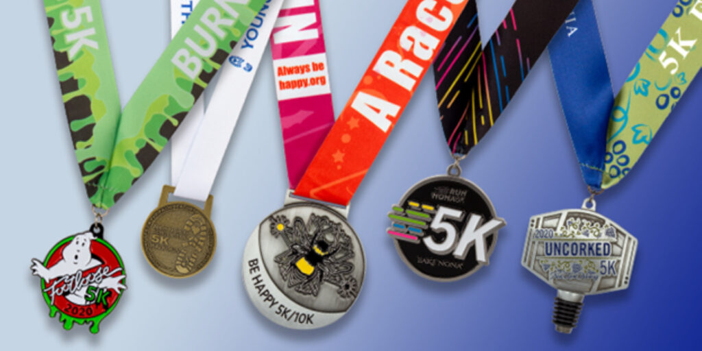Sports medals from various 5K races with colorful custom ribbons and unique designs displayed on blue background